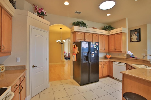 kitchen featuring sink, a notable chandelier, white dishwasher, decorative light fixtures, and black fridge with ice dispenser