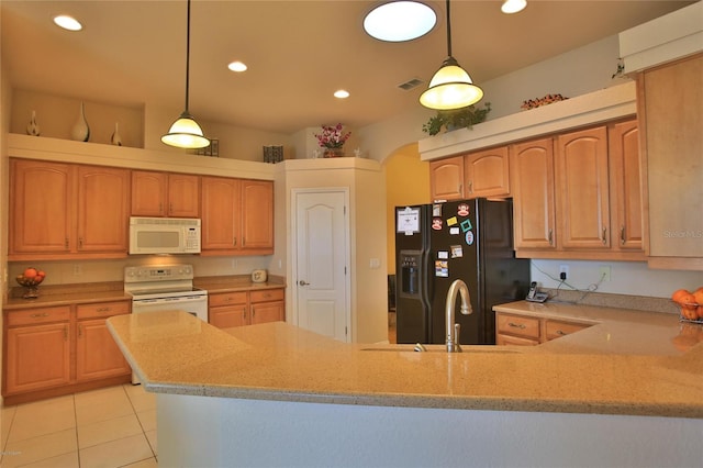 kitchen with decorative light fixtures, white appliances, sink, and light tile patterned floors