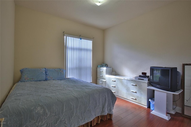 bedroom with dark wood-type flooring