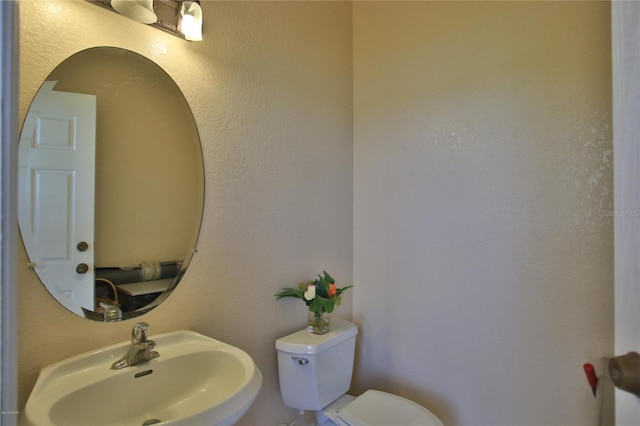 bathroom with toilet and sink