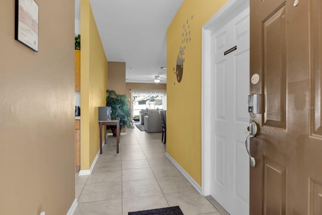 hall with light tile patterned floors