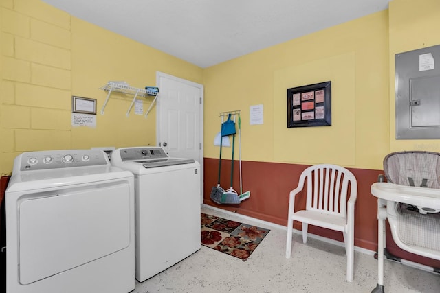 clothes washing area with separate washer and dryer and electric panel