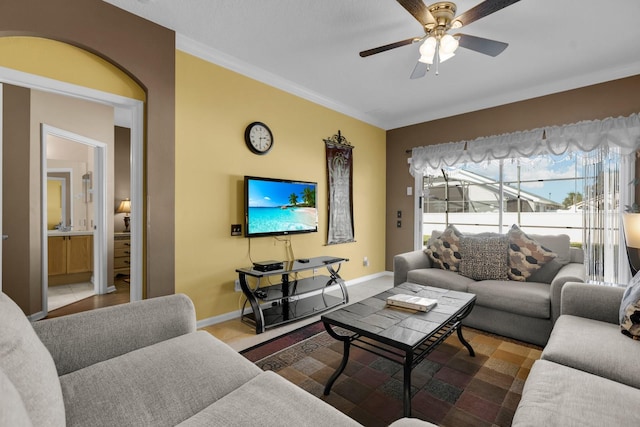 tiled living room featuring ceiling fan and ornamental molding