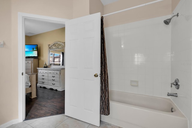 bathroom with hardwood / wood-style floors and shower / bath combo