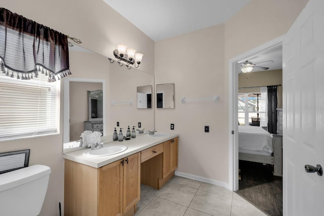 bathroom with toilet, vanity, tile patterned floors, and ceiling fan