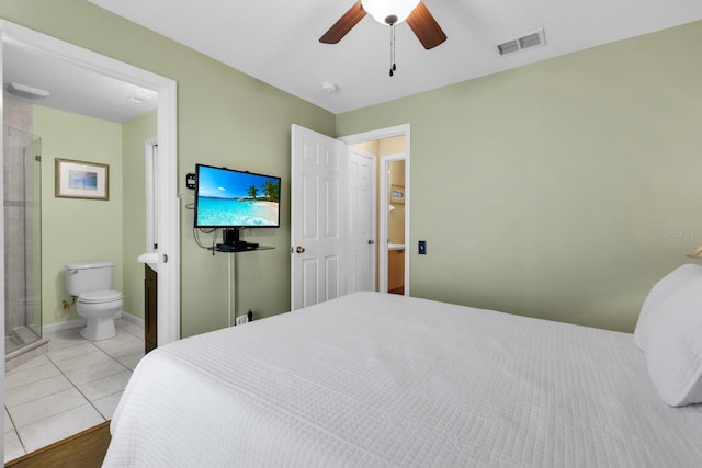 tiled bedroom featuring ensuite bath and ceiling fan