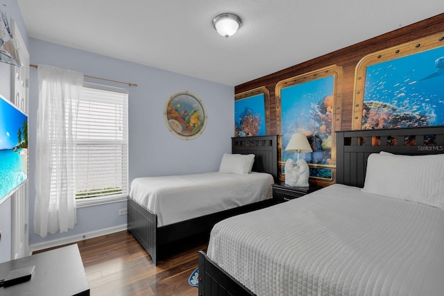 bedroom with dark wood-type flooring