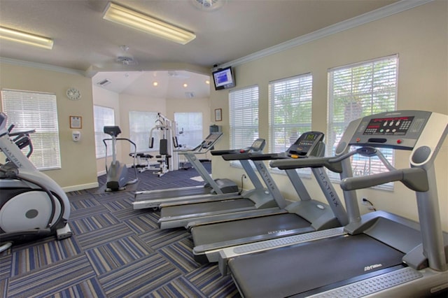 gym featuring ceiling fan and ornamental molding