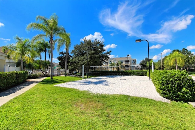 view of home's community featuring a yard and volleyball court