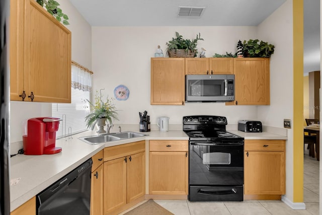 kitchen with black appliances, sink, and light brown cabinetry