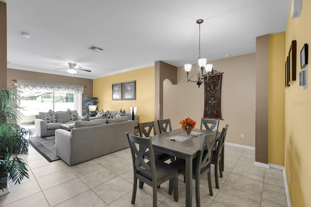 tiled dining area featuring ceiling fan with notable chandelier