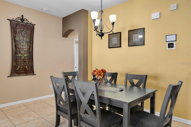 dining area featuring a notable chandelier and light tile patterned floors