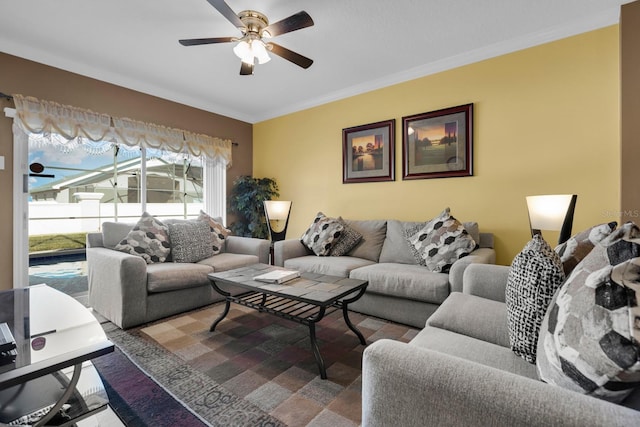 living room featuring crown molding and ceiling fan