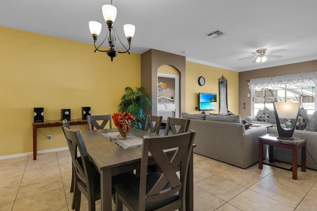 dining room featuring light tile patterned floors, ceiling fan with notable chandelier, and ornamental molding