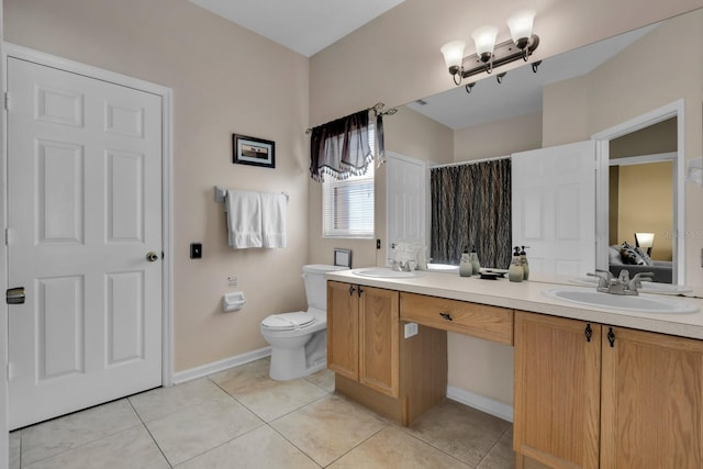 bathroom with tile patterned floors, vanity, and toilet