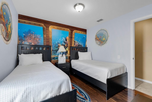 bedroom with dark wood-type flooring