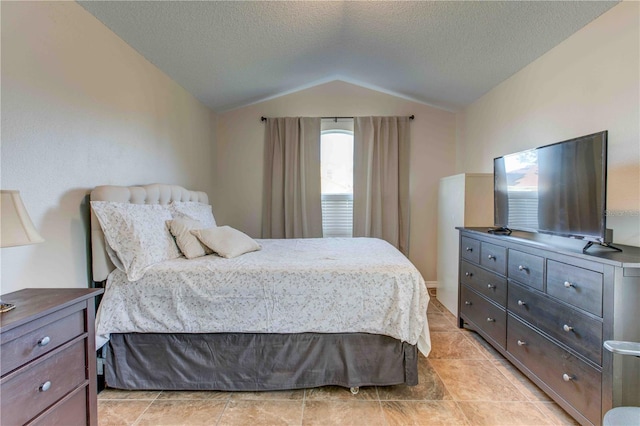 bedroom with a textured ceiling and lofted ceiling