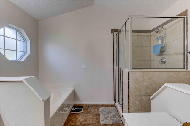 bathroom with tile patterned flooring, separate shower and tub, lofted ceiling, and a textured ceiling