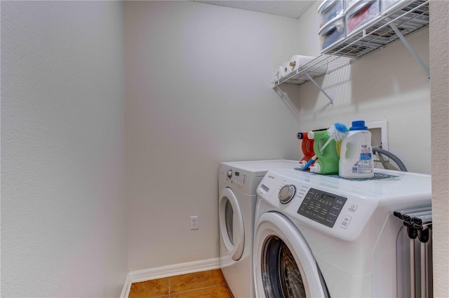 laundry room featuring tile patterned floors and washer and dryer