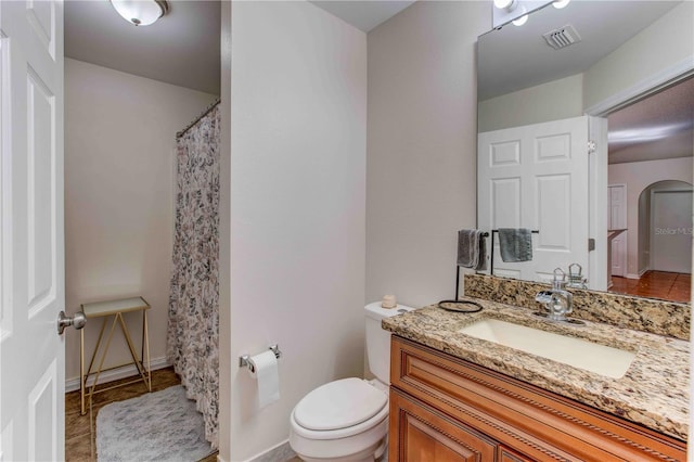 bathroom featuring tile patterned floors, vanity, and toilet