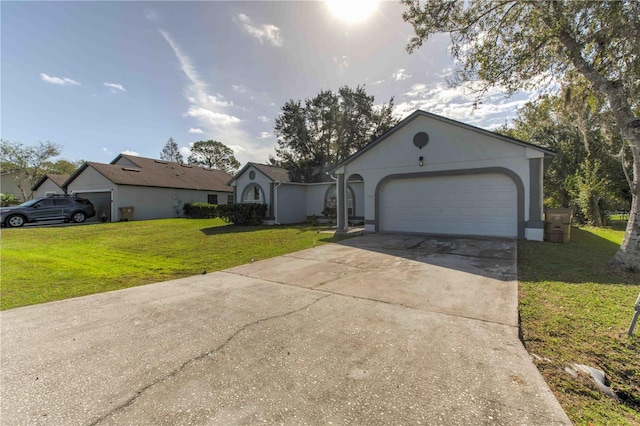 single story home with a garage and a front lawn