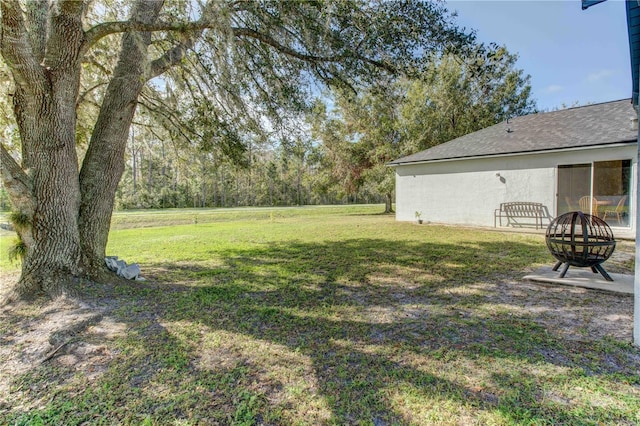 view of yard with an outdoor fire pit