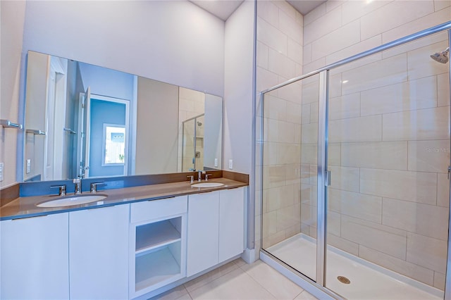 bathroom featuring tile patterned floors, vanity, and a shower with door