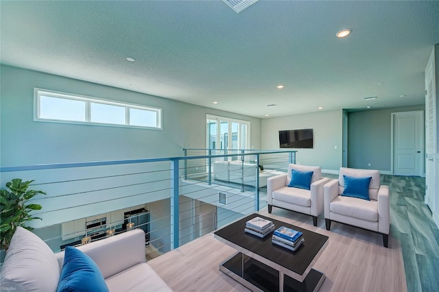 living room with hardwood / wood-style floors and a textured ceiling