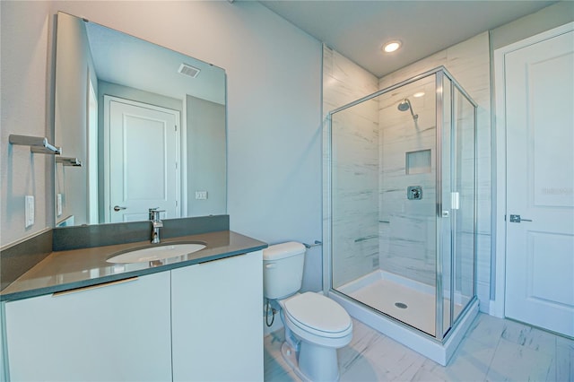 bathroom featuring an enclosed shower, vanity, and toilet