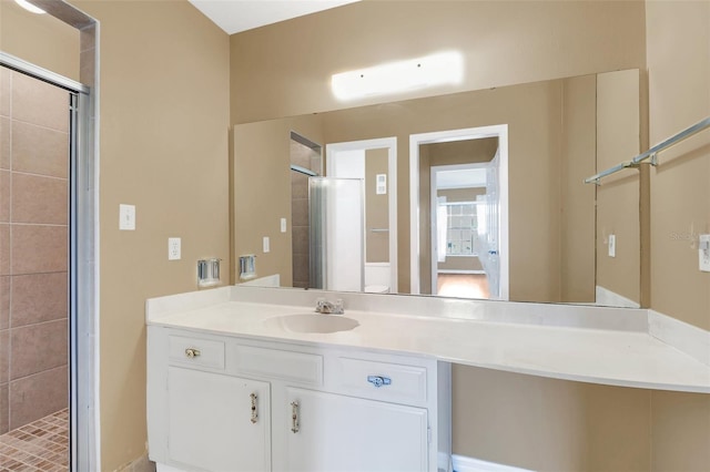 bathroom featuring vanity, toilet, and a shower with shower door