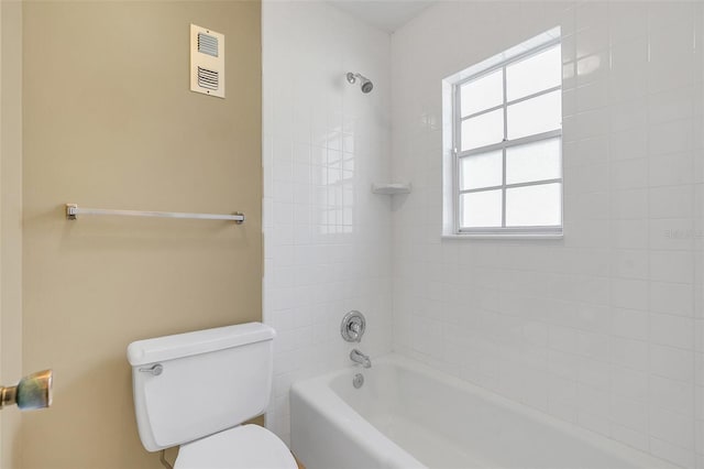 bathroom featuring tiled shower / bath and toilet