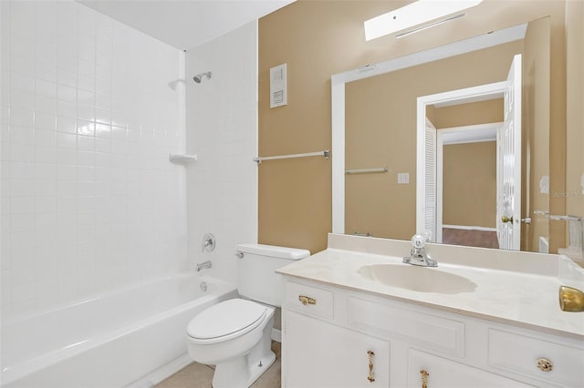 full bathroom featuring vanity, tiled shower / bath, a skylight, and toilet