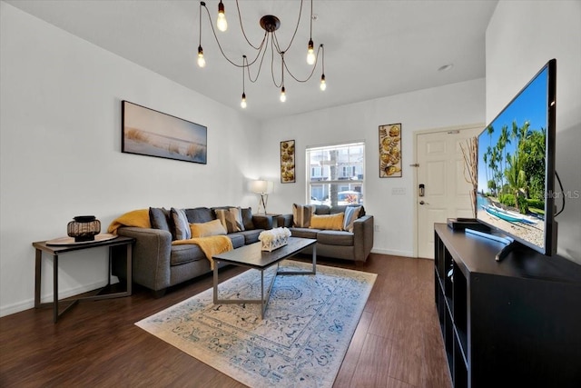 living room featuring dark wood-type flooring and a notable chandelier