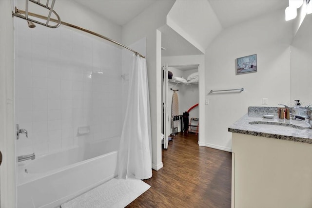 bathroom with wood-type flooring, vanity, and shower / tub combo with curtain