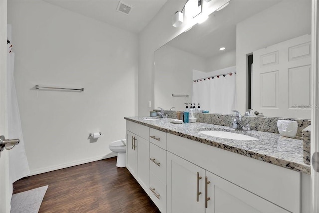 bathroom featuring hardwood / wood-style flooring, vanity, and toilet