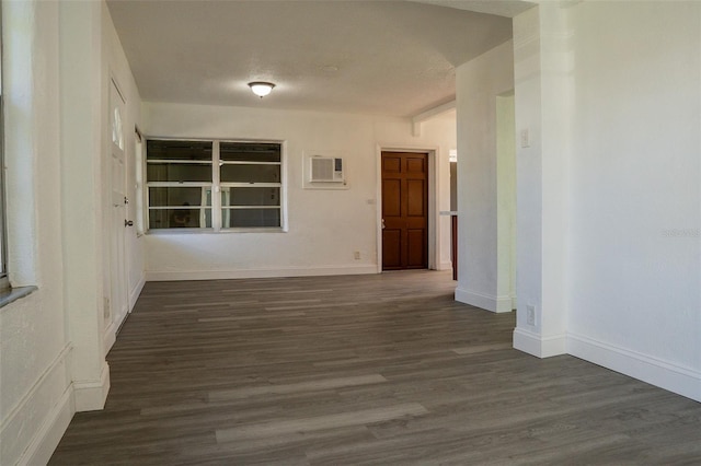 hallway featuring a wall mounted air conditioner and dark wood-type flooring