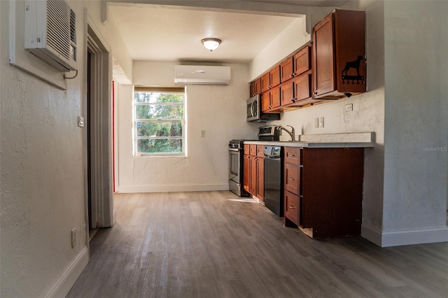 kitchen featuring a wall mounted air conditioner, sink, dark wood-type flooring, and appliances with stainless steel finishes