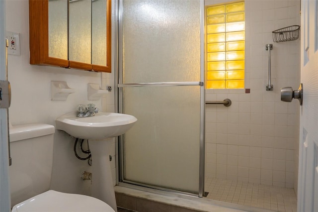 bathroom featuring sink, toilet, and walk in shower