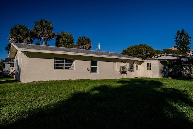 rear view of house featuring a yard