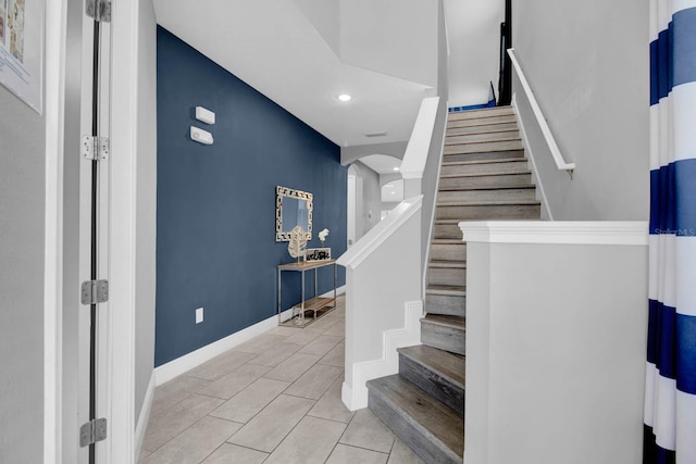 staircase featuring tile patterned floors