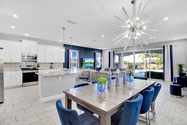 dining area with an inviting chandelier