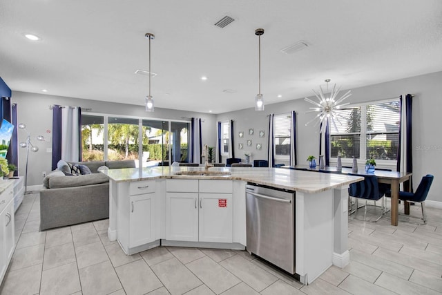 kitchen featuring white cabinets, dishwasher, a kitchen island, and sink