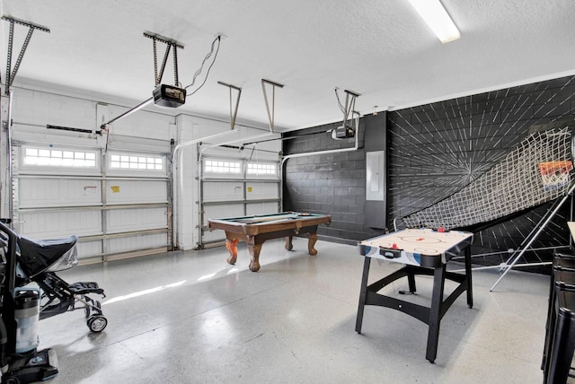 garage with electric panel and a garage door opener