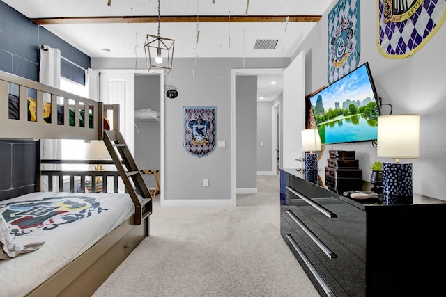 carpeted bedroom featuring beamed ceiling