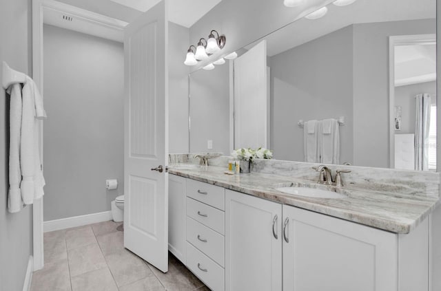 bathroom with tile patterned floors, vanity, and toilet