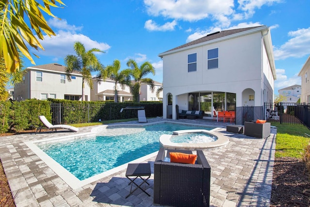 view of pool with an in ground hot tub, an outdoor living space, and a patio