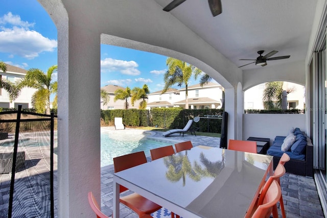 view of patio featuring a fenced in pool and ceiling fan