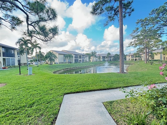 surrounding community featuring a yard and a water view