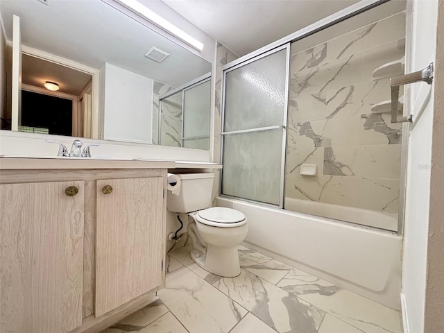 full bathroom with vanity, bath / shower combo with glass door, and toilet