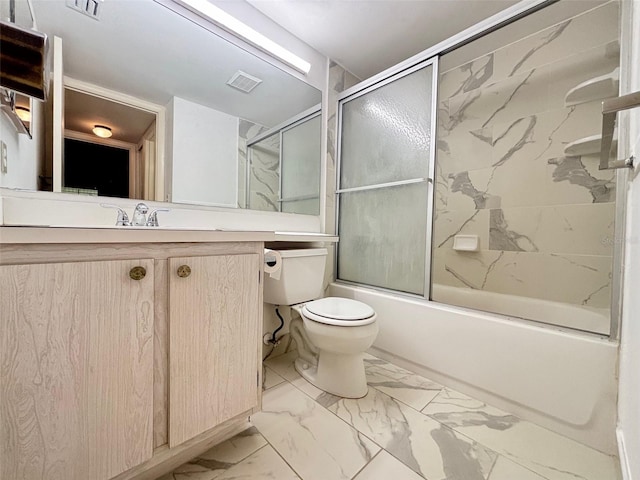 full bathroom with vanity, bath / shower combo with glass door, and toilet